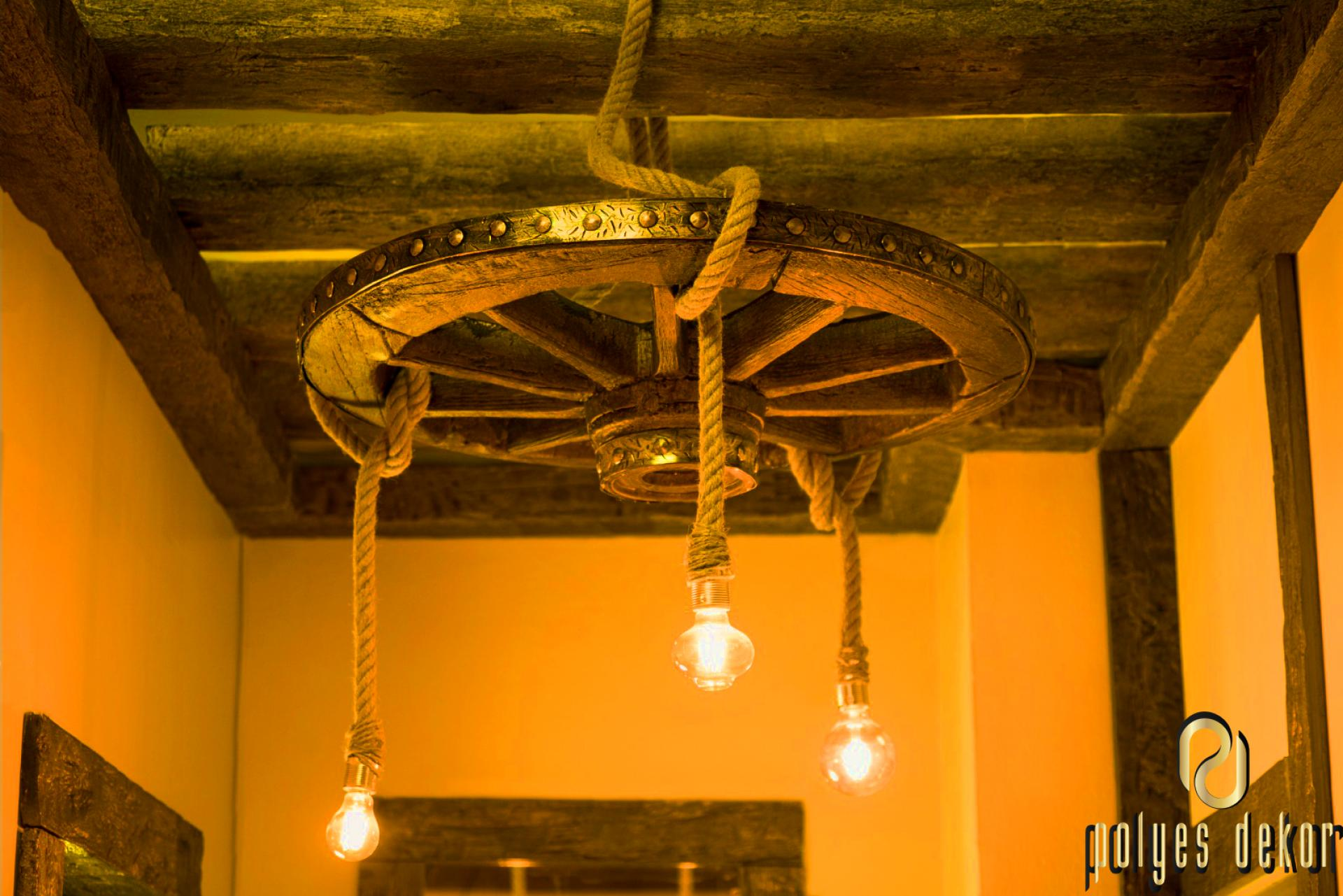Candelabru din roata de car cu franghii si becuri Edison sub tavan cu grinzi