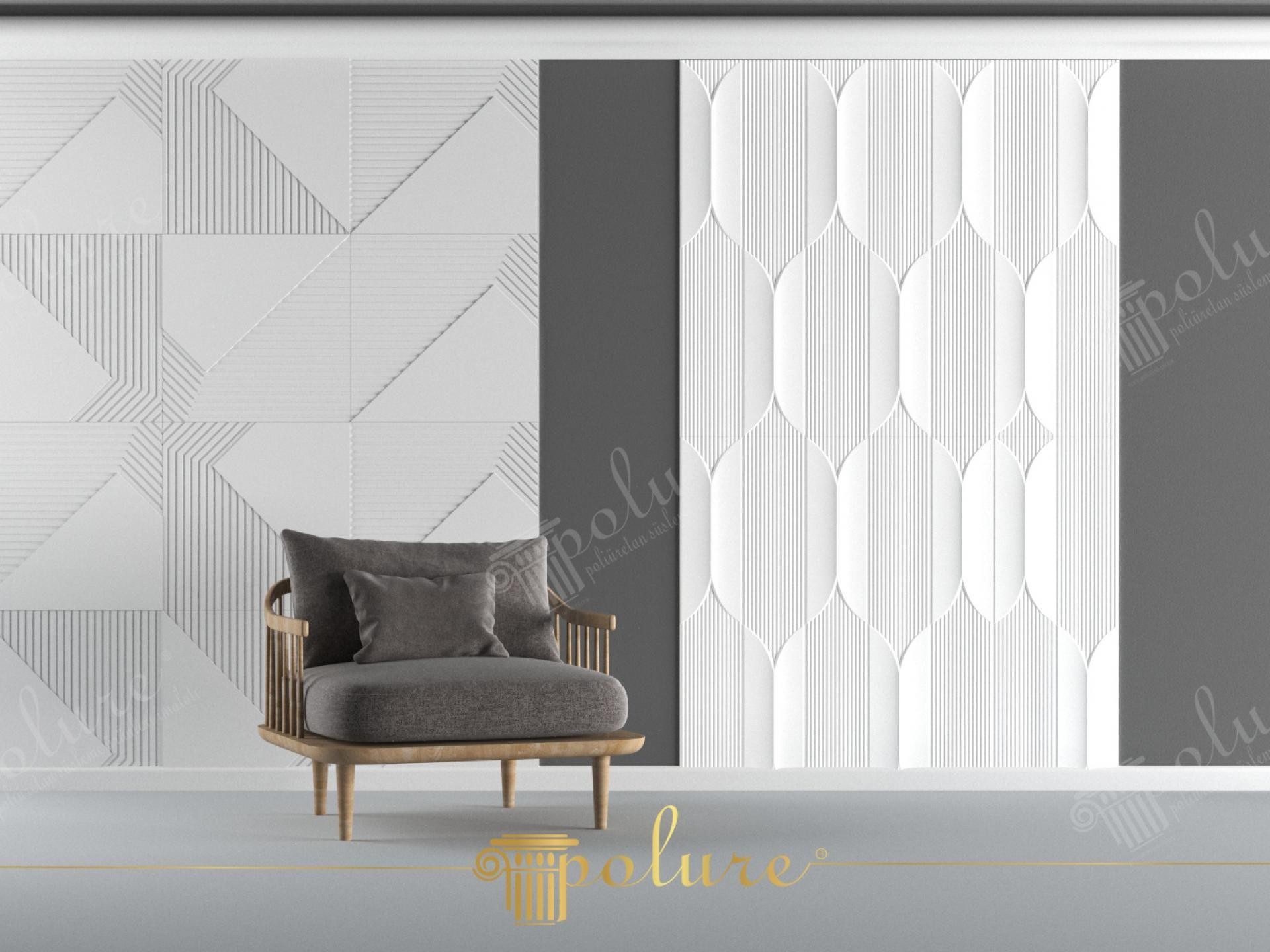 Perete modern cu panouri decorative 3D albe geometrice și fotoliu gri