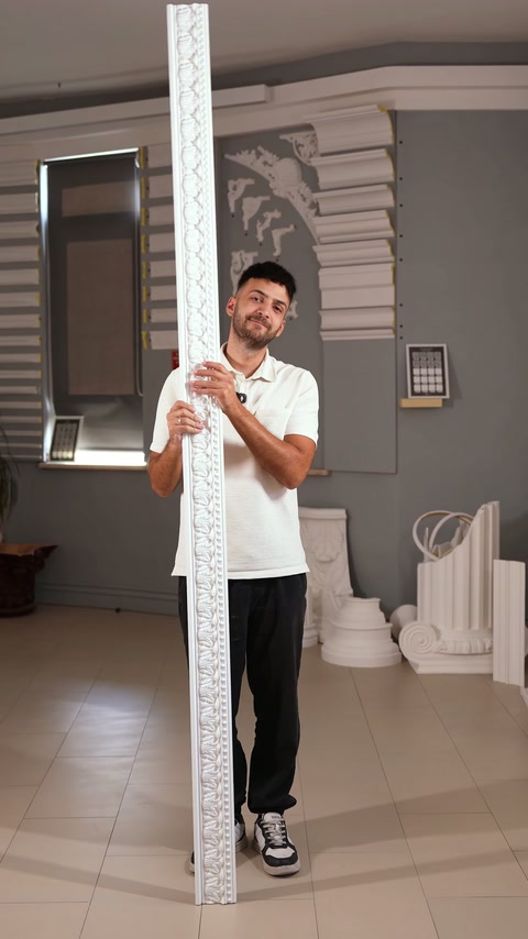 Brâul rigid cu relief este expus vertical lângă mostrele decorative.