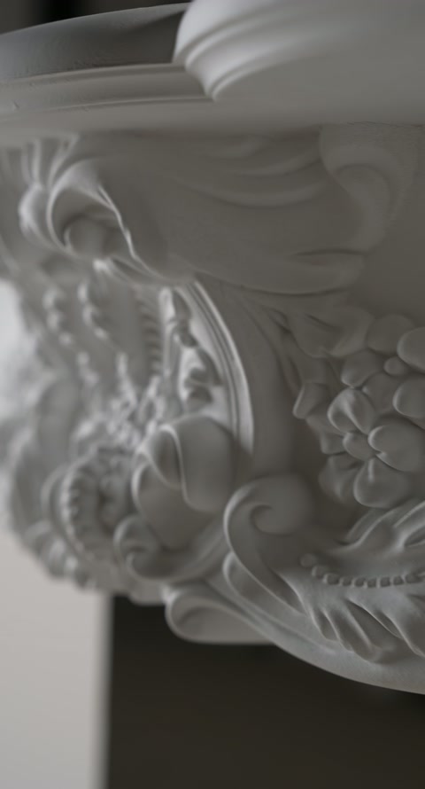 Compoziție sculpturală de pe ancadrament, cu motive botanice suprapuse.