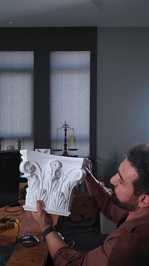 Bărbat ține un capitel de coloană poliuretan sculptat manual